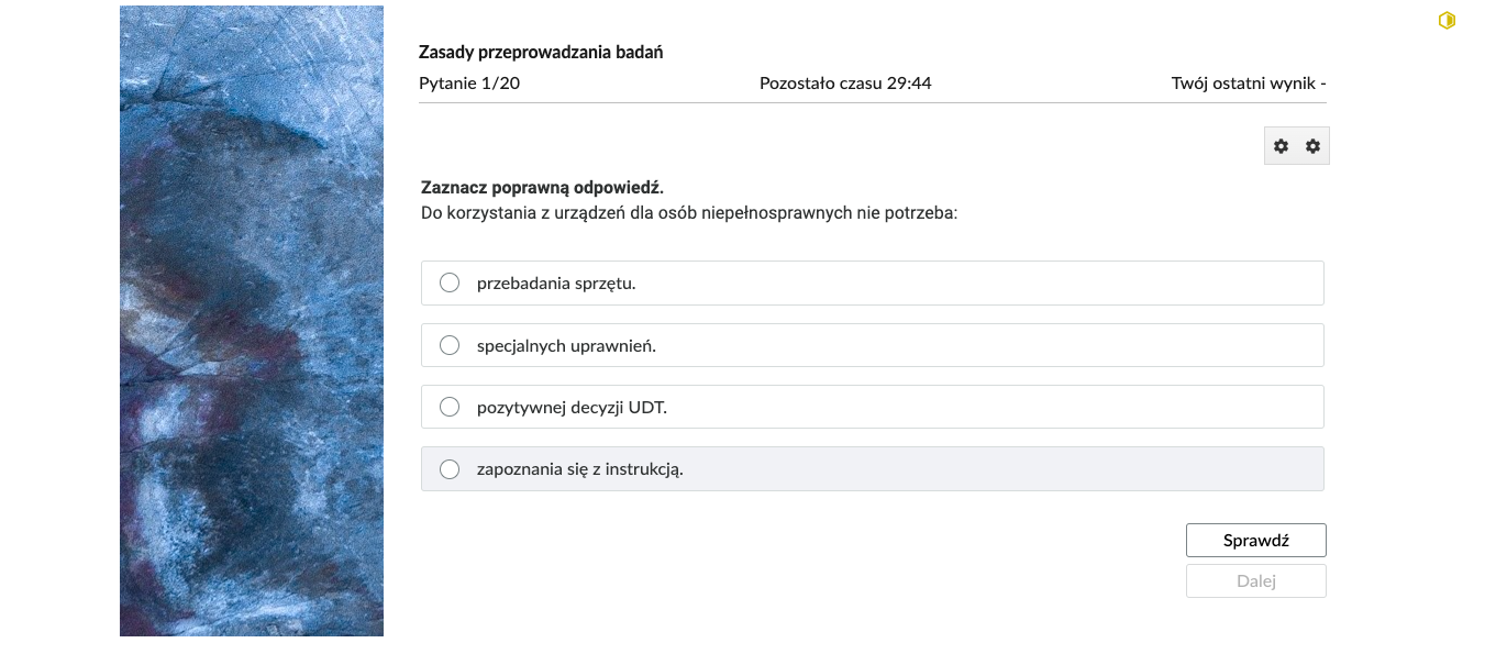 Grafika przedstawia przykładowe zadanie testowe. Ponad poleceniem widać numer pytania, czas, który pozostał na wypełnianie testu, oraz ostatni uzyskany wynik. Pod poleceniem znajdują się możliwe odpowiedzi. W prawym dolnym rogu panelu z zadaniem znajdują się dwa przyciski. Są to "Sprawdź" oraz "Dalej".