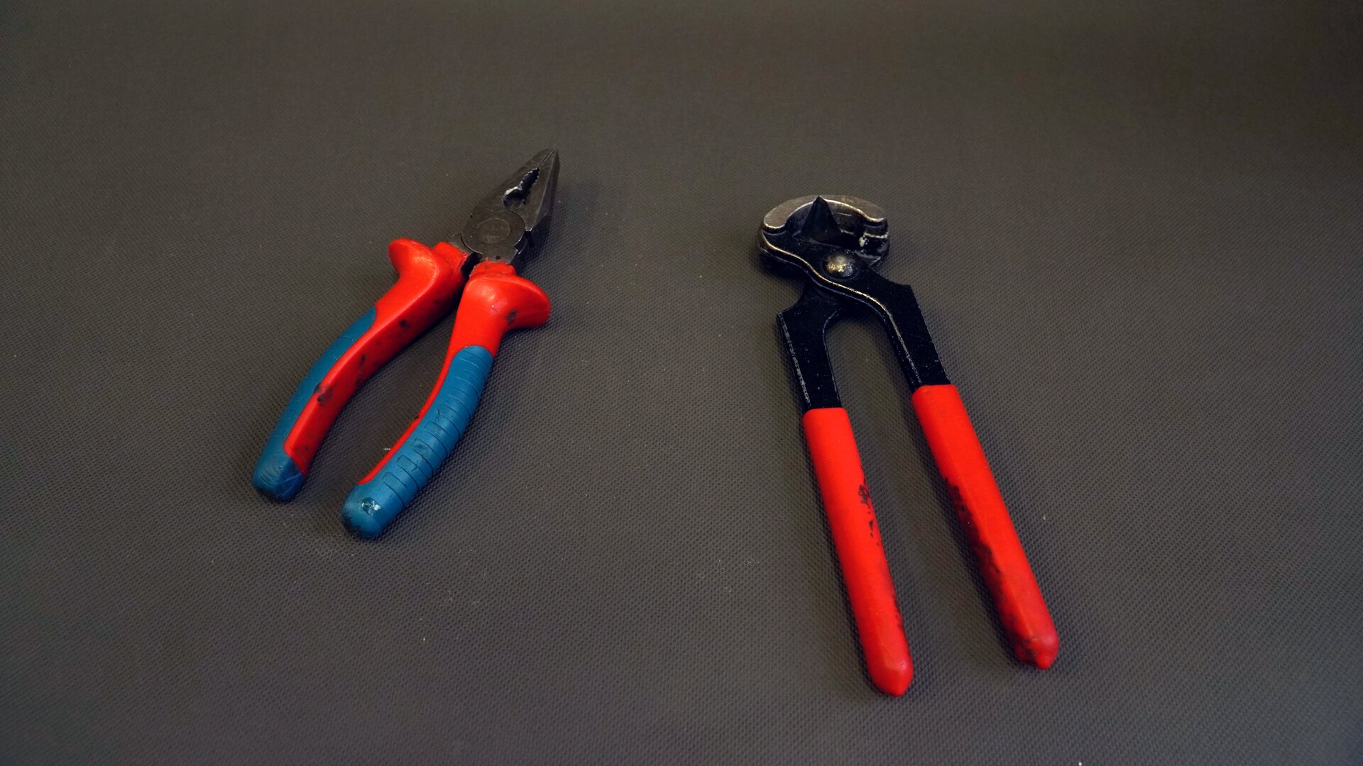 Zdjęcie przedstawia dwie pary obcęgów. Narzędzie skład się z dwóch części połączonych ruchomo. Część roboczą stanowią łukowate szczęki zakończone ostrzami.