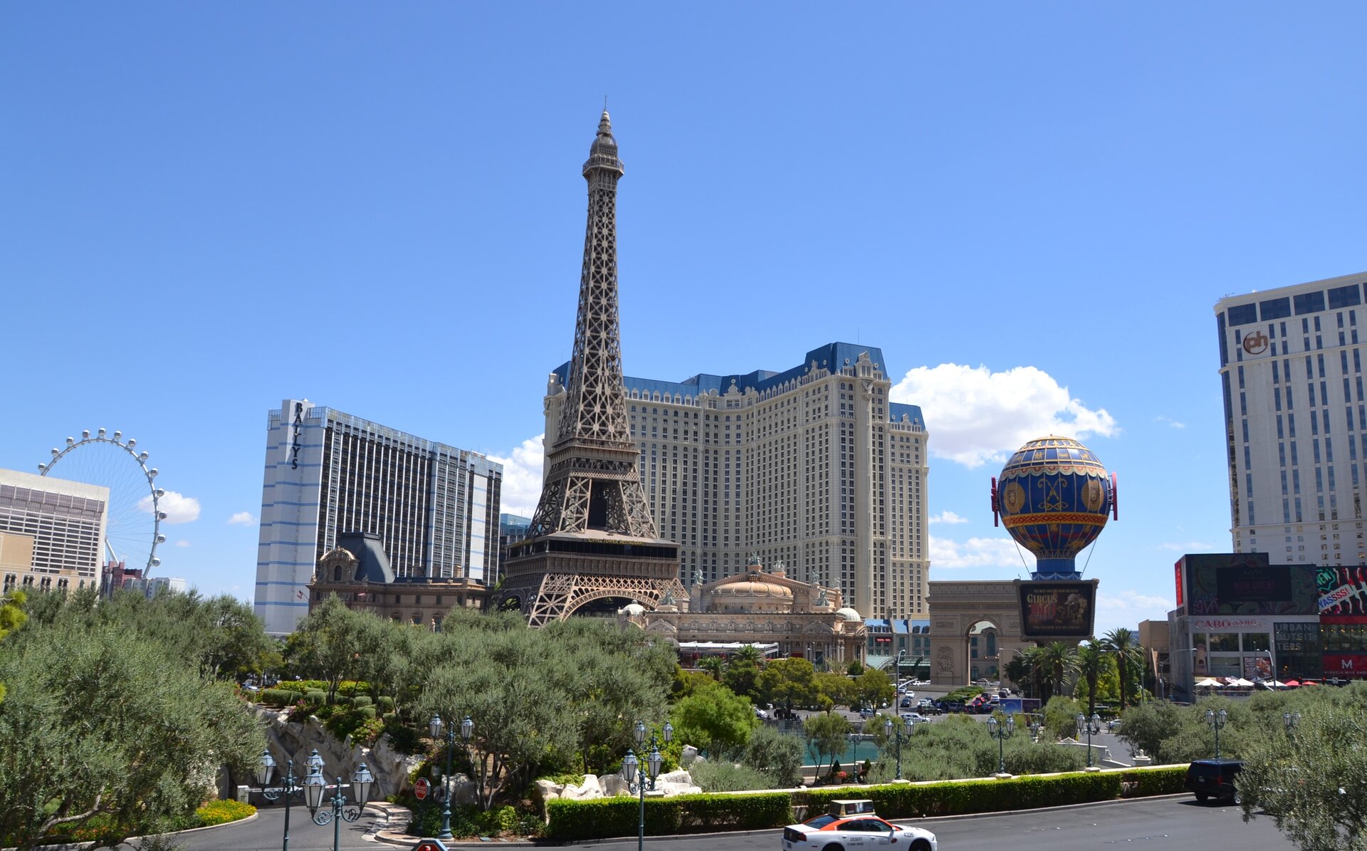 Fotografia przedstawia fragment miasta Las Vegas : jezdnię i budynki hotelowe. Pomiędzy zabudowaniami znajduje się pomniejszona kopia Wieży Eiffla.