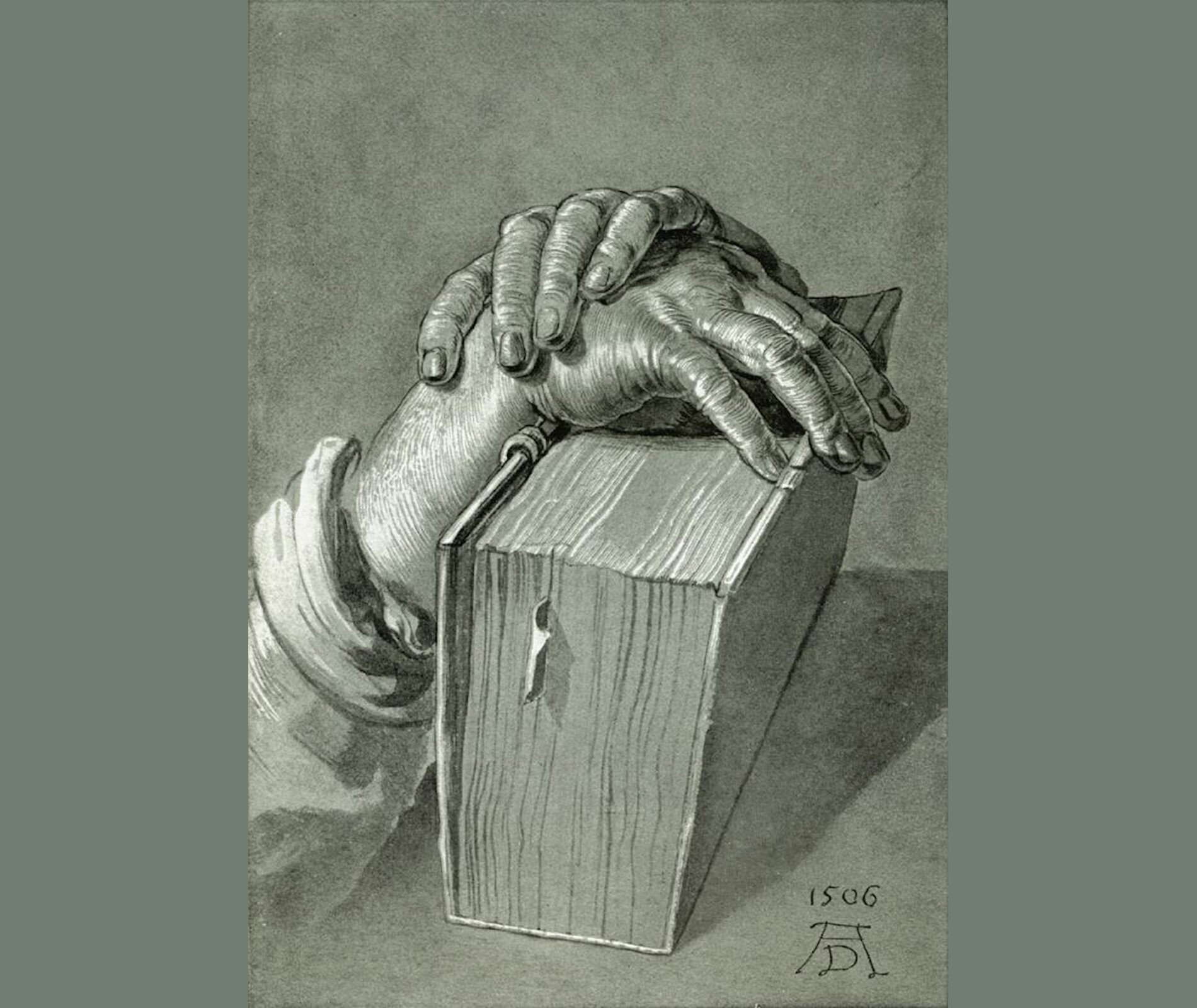 Rycina przedstawia dwie dłonie trzymające grubą książkę.