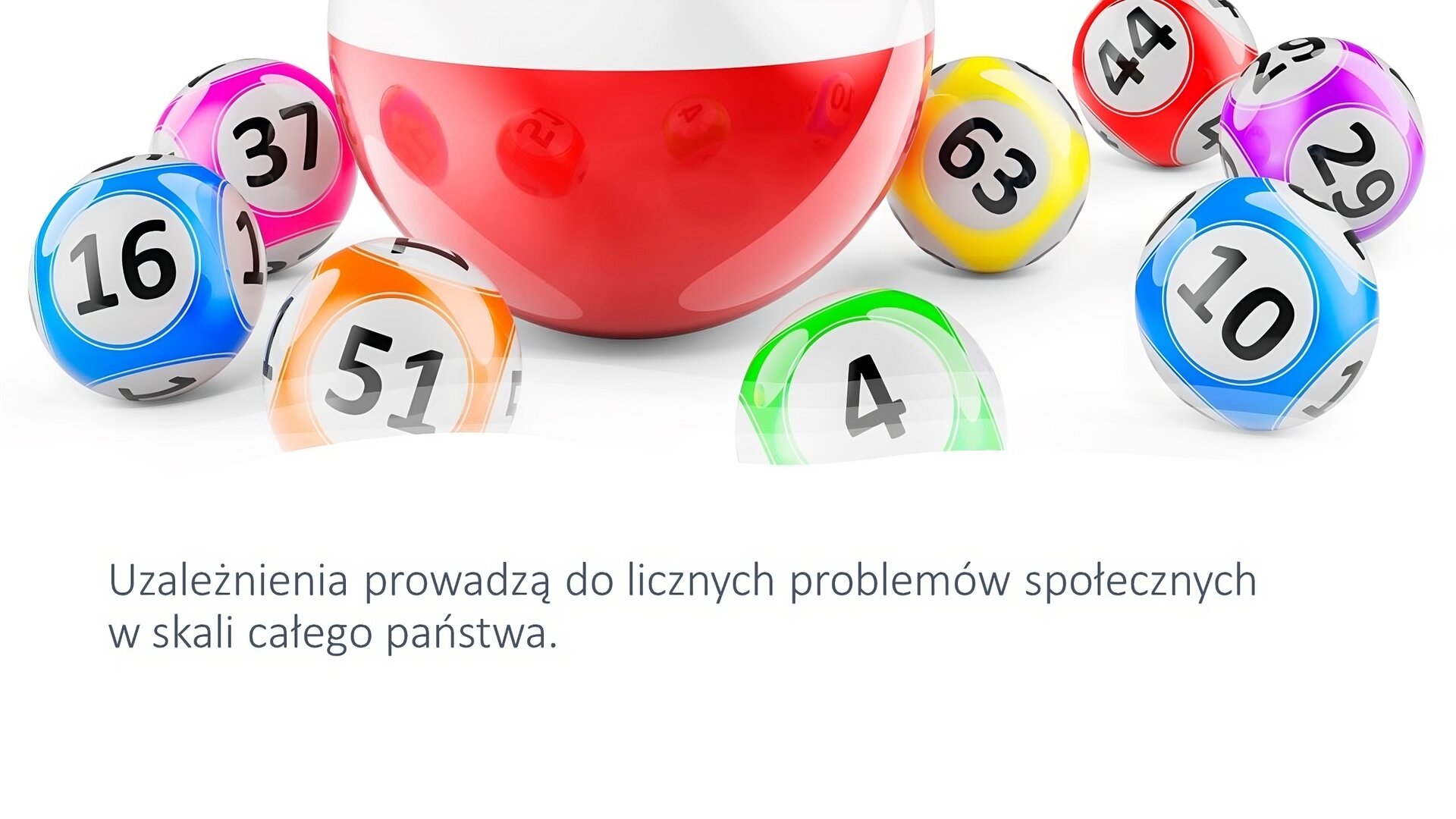 Biały slajd. W górnej jego części zdjęcie przedstawiające małe kolorowe kulki z liczbami: 16, 37, 51, 4, 63, 44, 10, 29. Na środku duża, biało‑czerwona kulka. W dolnej części slajdu tekst: „Uzależnienia prowadzą do licznych problemów społecznych w skali całego państwa”.