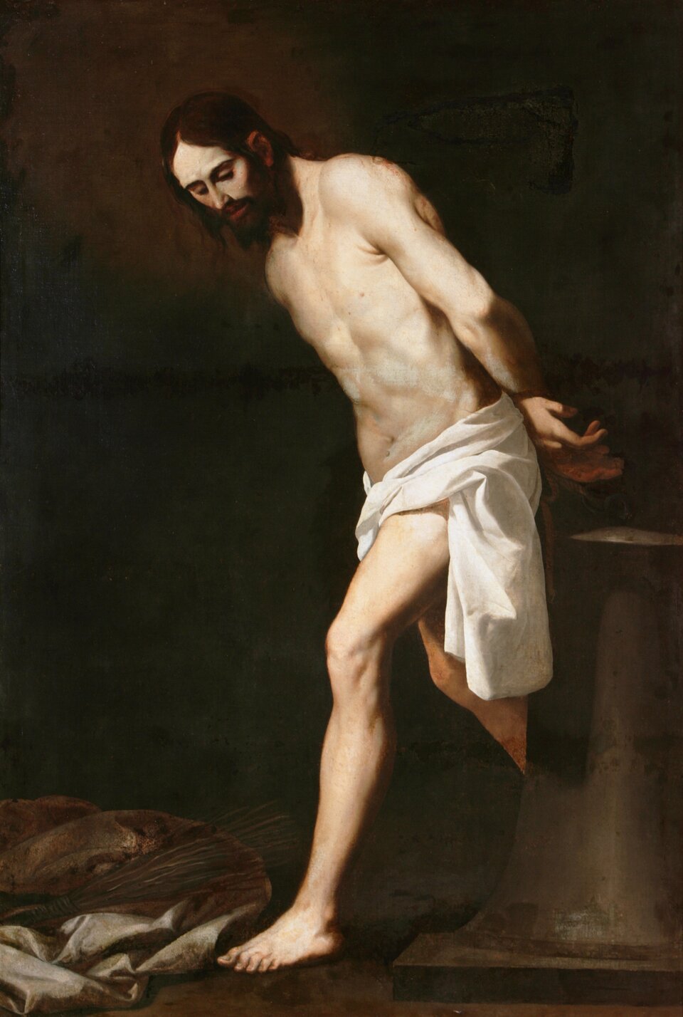 Ilustracja przedstawia obraz Francisco de Zurbarána „Chrystus przy kolumnie biczowania”. Ukazuje Chrystusa stojącego przy kolumnie. Mężczyzna ma skrzyżowane ręce za plecami. W pasie przyodziany jest w białą szatę. Przed mężczyzną na ziemi leżą porozrzucane tkaniny.
