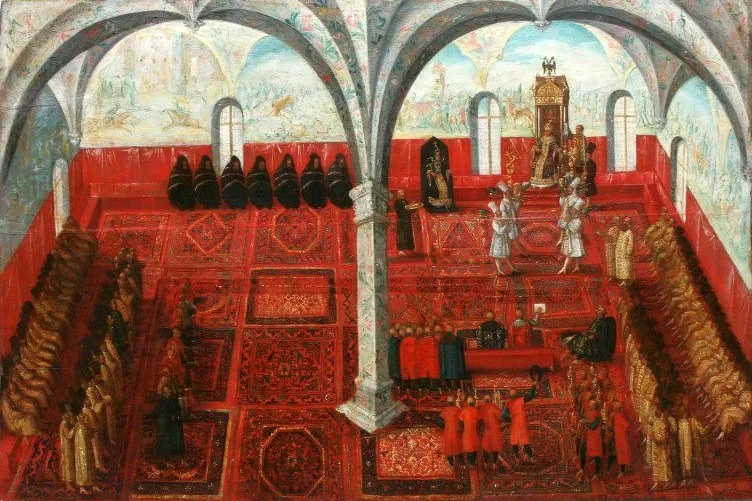 Kliknij, aby powiększyć. Na ilustracji przedstawiono przyjęcie polskiego poselstwa przez cara Dymitra (Samozwańca I). Na sali znajduje się wiele osób. Na jej środku widoczny jest filar sięgający sufitu.