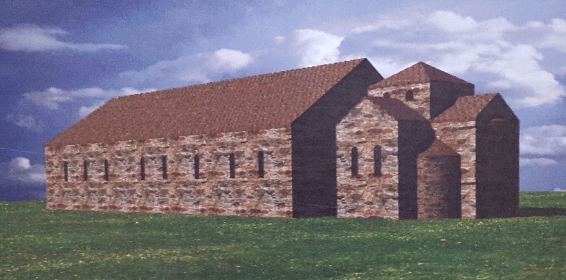 Zdjęcie przedstawia budynek. Ma spadzisty dach, małe okna, z prawej strony budynku są trzy wieże.