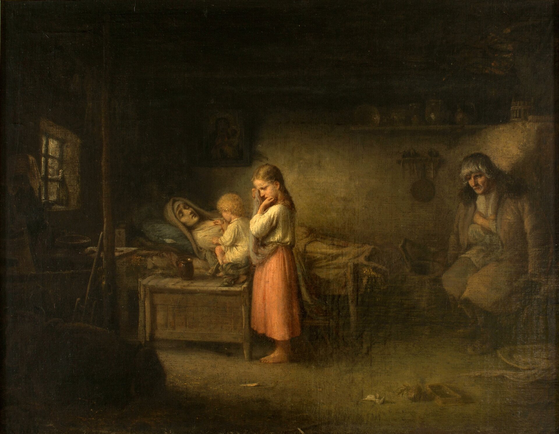 Zdjęcie przedstawia scenę rodzajową. W chłopskim domu, w izbie stoi skromne łóżko. Leżą na nim zwłoki młodej kobiety. Przy łóżku stoi kilkuletnia dziewczynka. Płacze, przecierając fartuchem oczy. Przy zmarłej znajduje się także małe dziecko w koszuli. Nieopodal łóżka siedzi mężczyzna. Jest zasmucony.