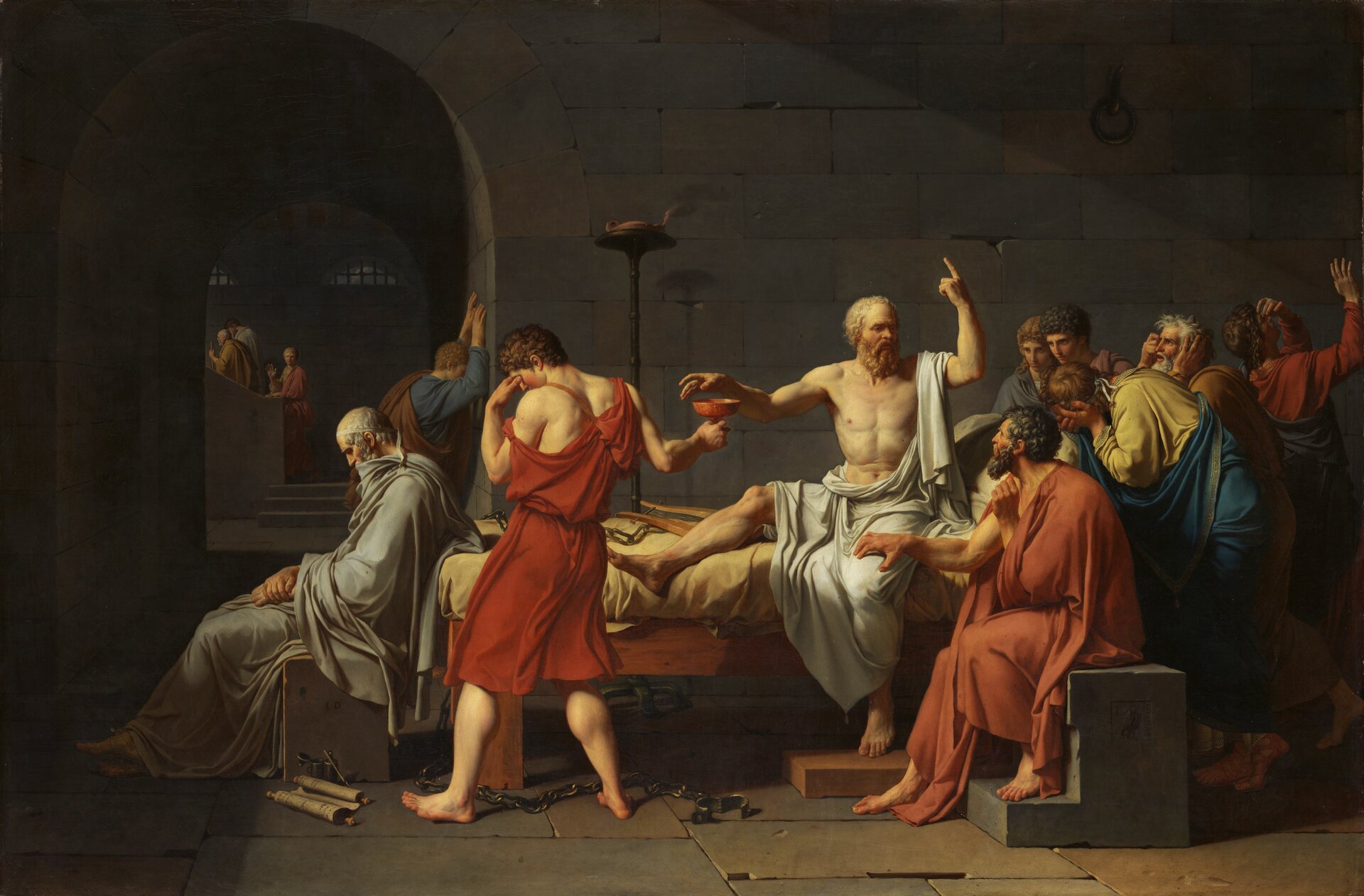 Kolorowa ilustracja przedstawia dzieło Jeana Luisa Davida pt. „Śmierć Sokratesa”. W centrum obrazu widnieje postać filozofa siedzącego na łożu. Przez ramię oraz tułów ma przerzuconą białą szatę. Łoże otaczają jego uczniowie. Jeden , odziany w czerwoną szatę, odwrócony bokiem do nauczyciela, podaje mu kielich z cykutą. Sokrates sięga po truciznę, drugą rękę zaś unosi do góry. Rozmawia z uczniami, którzy wsłuchani są w jego słowa.