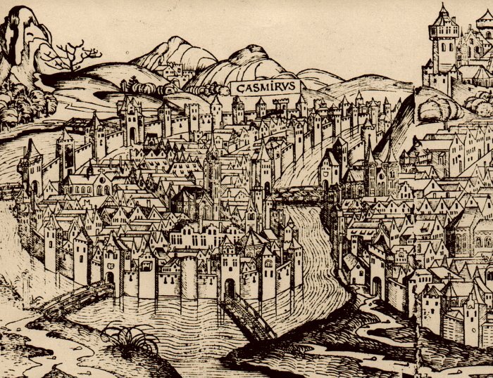 Ilustracja przedstawia miasto. Jest ono z każdej strony otoczone rzeką. Miasto jest gęsto zabudowane. Miasto z brzegiem łączą w kilku miejscach mosty. W tle znajdują się wzgórza.