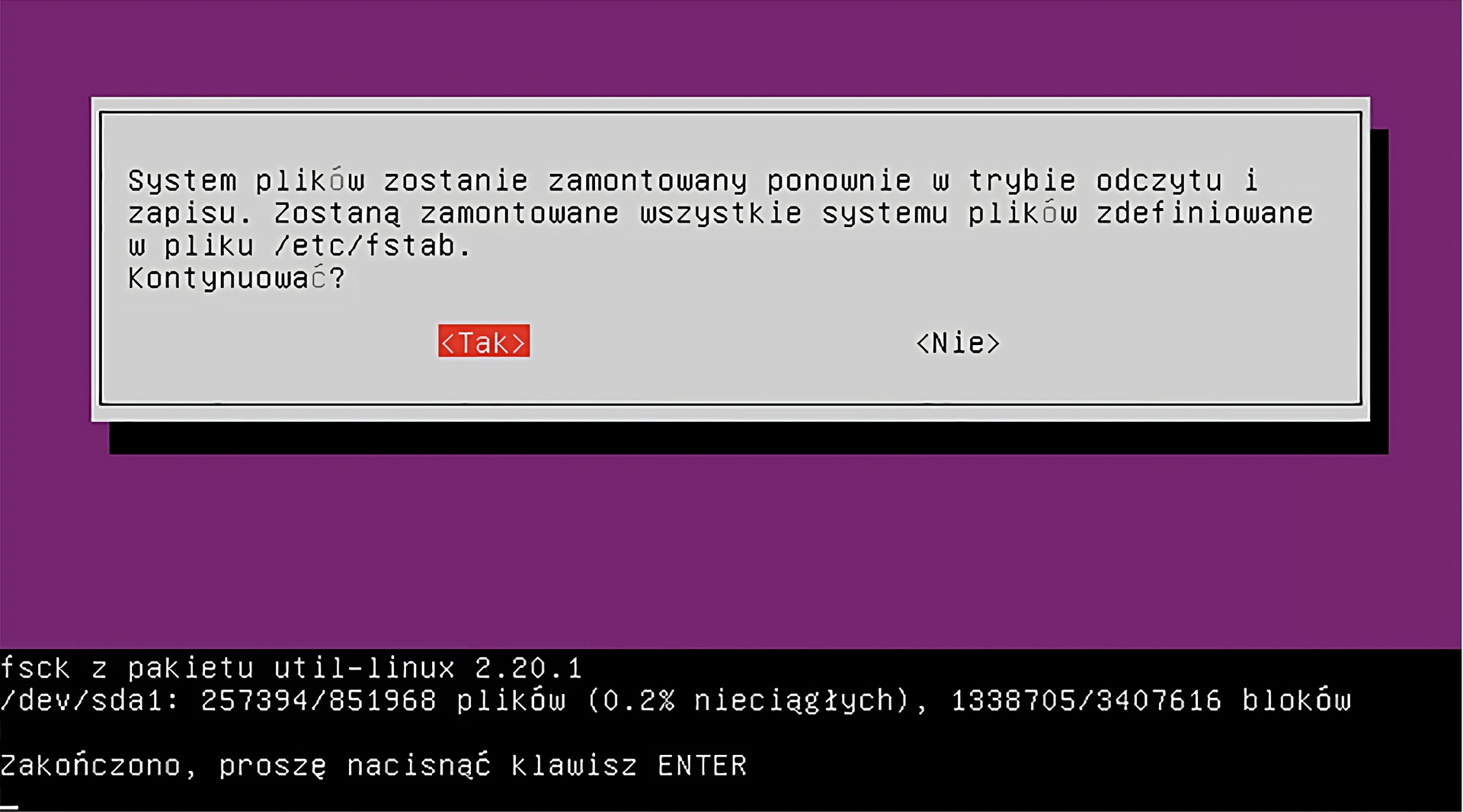 Ilustracja przedstawia okno dialogowe w trybie awaryjnym systemu Linux Ubuntu. Zawiera ono informację: System plików zostanie zamontowany ponownie w trybie odczytu i zapisu. Zostaną zamontowane wszystkie systemu plików zdefiniowane w pliku /etc/fstab. Kontynuować? Pod spodem znajduje się fragment okna terminala, w którym zostajemy poinformowani o wykonaniu i zakończeniu procesu.