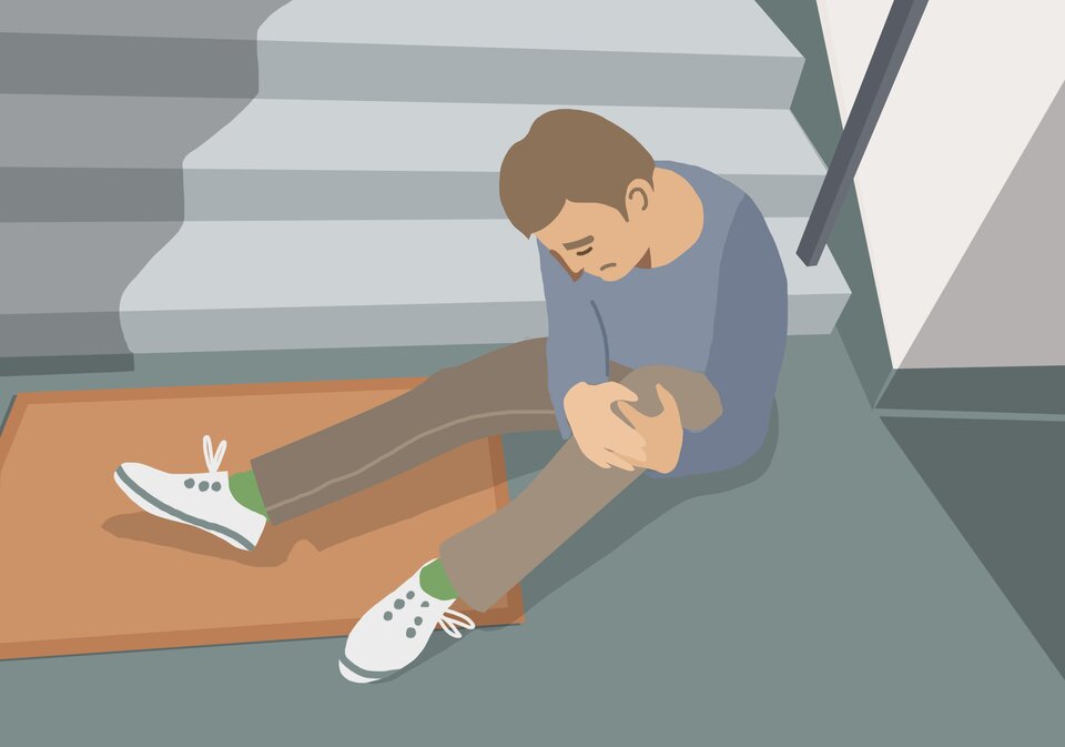 Widoczna jest ilustracja. Przedstawia smutnego mężczyznę siedzącego przy schodach i trzymającego się za kolano.