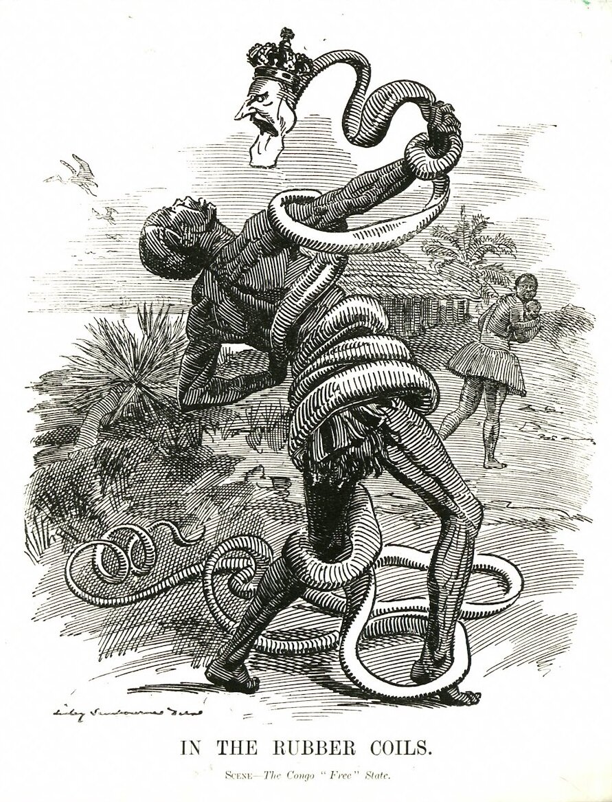 Ilustracja przedstawia czarnoskórego mężczyznę. Walczy z owijającym się wokół niego wężem. Wąż ma ludzką głowę białego człowieka w królewskiej koronie. W tle ucieka czarnoskóra kobieta z dzieckiem na rękach. Pod spodem ilustracji jest napis: In the rubber coils.