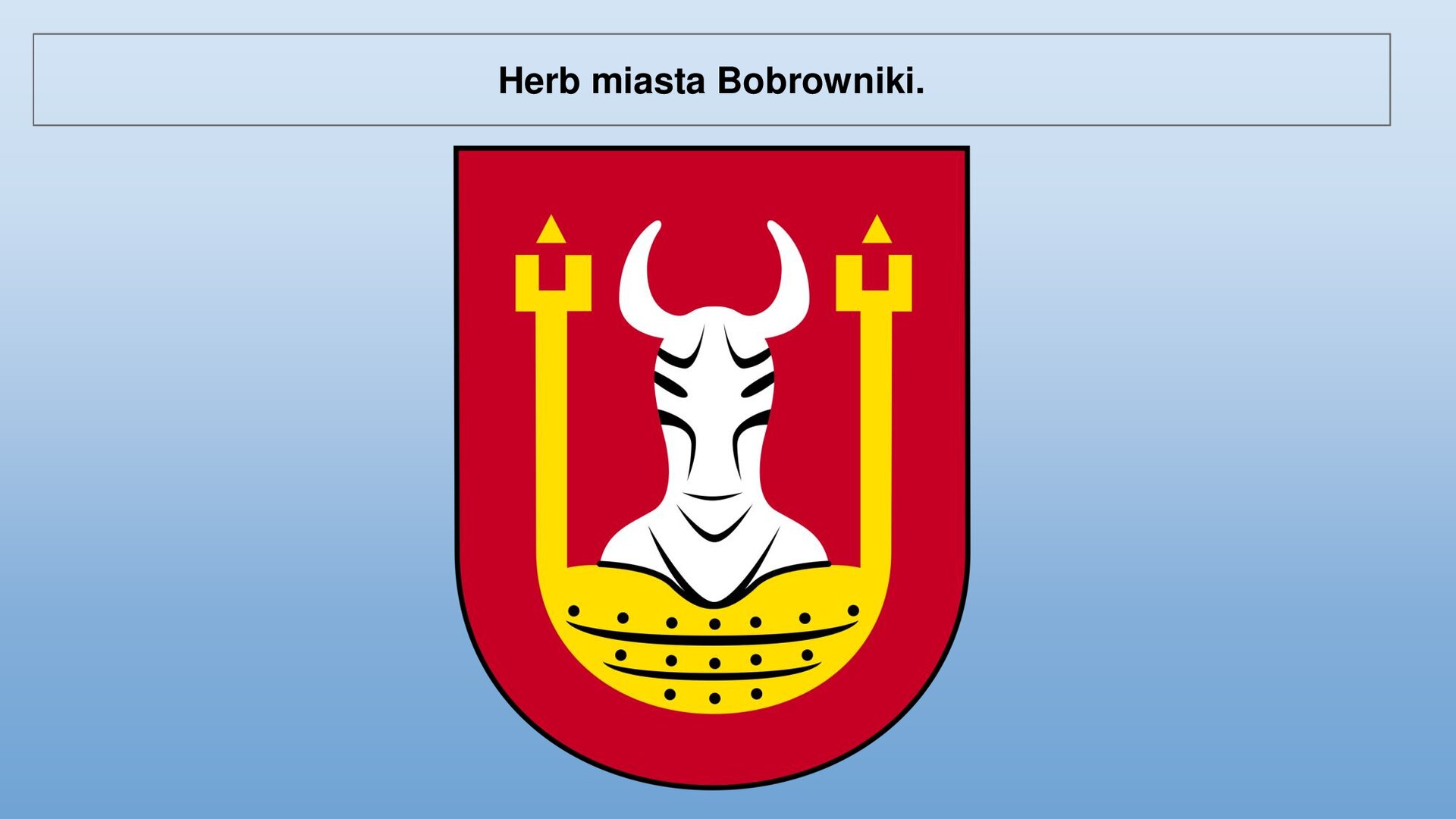 Niebieski slajd. U góry nagłówek: „Herb miasta Bobrowniki”. Niżej czerwony herb, przedstawiający złotą podkowę, pomiędzy którą znajduje się biała sylwetka z rogami.