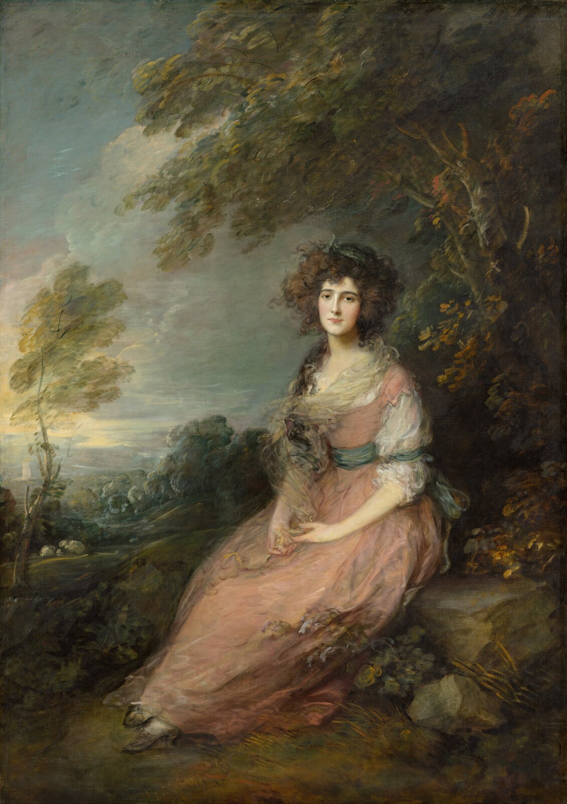 Ilustracja przedstawia obraz „Portret Elizabeth Sheridan” autorstwa Thomasa Gainsborougha. Obraz ukazuje kobietę ubraną w jasno-różową suknię z zielonym paskiem w pasie. Kobieta ma gęste, długie, kręcone włosy. Postać siedzi na skale, pod drzewem. W tle widoczne są drzewa i krzewy.