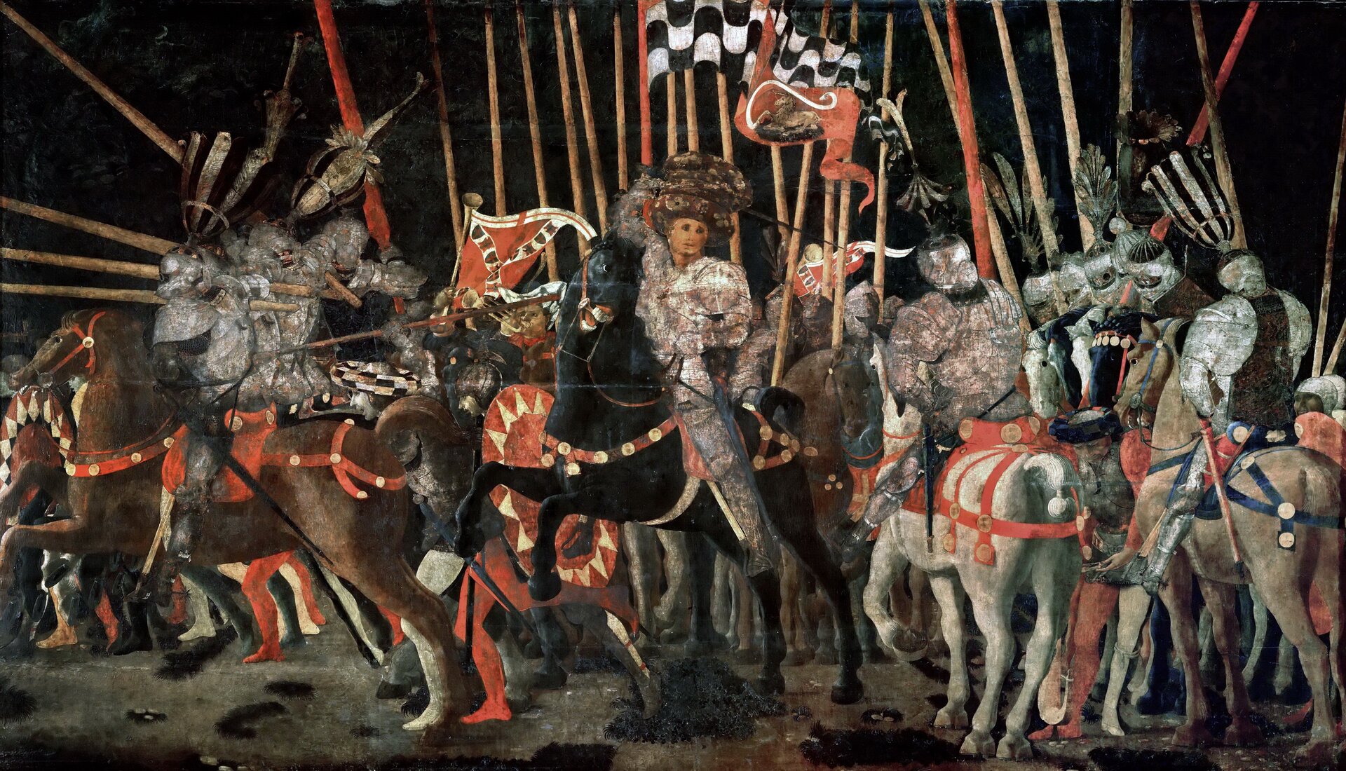 Ilustracja przedstawia obraz Paolo Uccello pt. „Bitwa pod San Romano (III)”. Na obrazie znajduje się tłum ludzi podczas bitwy. Bohaterowie znajdują się na koniach. W dłoniach trzymają miecze oraz flagi. Ubrani są w zbroje oraz na głowach mają hełmy. Konie także mają założone zbroje. Postacie na koniach ustawione są w jednym rzędzie - przodem do odbiorcy obrazu.