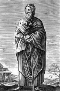 Czarnobiała grafika przedstawia postać stojącą w plenerze. Jest to mężczyzna w podeszłym wieku; ubrany jest w długą, mocno drapowaną szatę, na stopach ma sandały. Ma zarost; głowę okrywa mu zwinięta chusta. Ma złożone ręce oparte na lasce. 