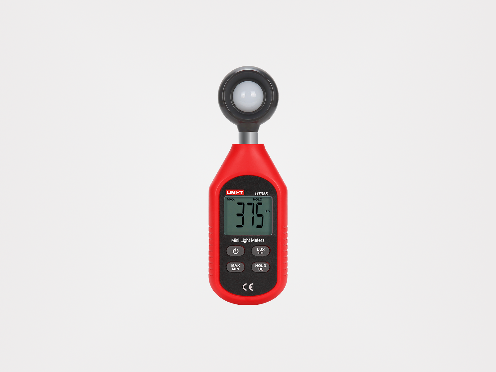 Ilustracja przedstawia przyrząd, na którego korpusie znajduje się ekran z wyświetloną wartością trzysta siedemdziesiąt pięć luksów. Poniżej widać cztery przyciski: pałer, lux pe ce, maks min oraz hold be el. Do górnej ściany przyrządu przymocowany jest okrągły element, ułożony równolegle do ściany. 