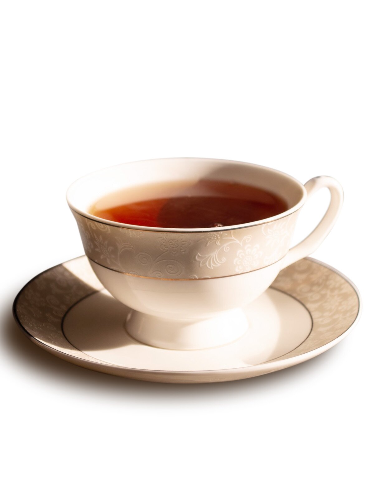 Ilustracja przedstawiająca herbatę w filiżance koloru kremowego.