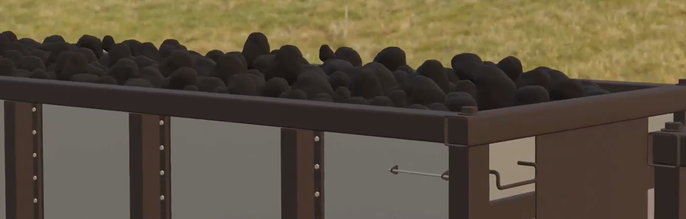 Ilustracja przedstawia górę wagonu towarowego. Na wagonie załadowany jest węgiel.