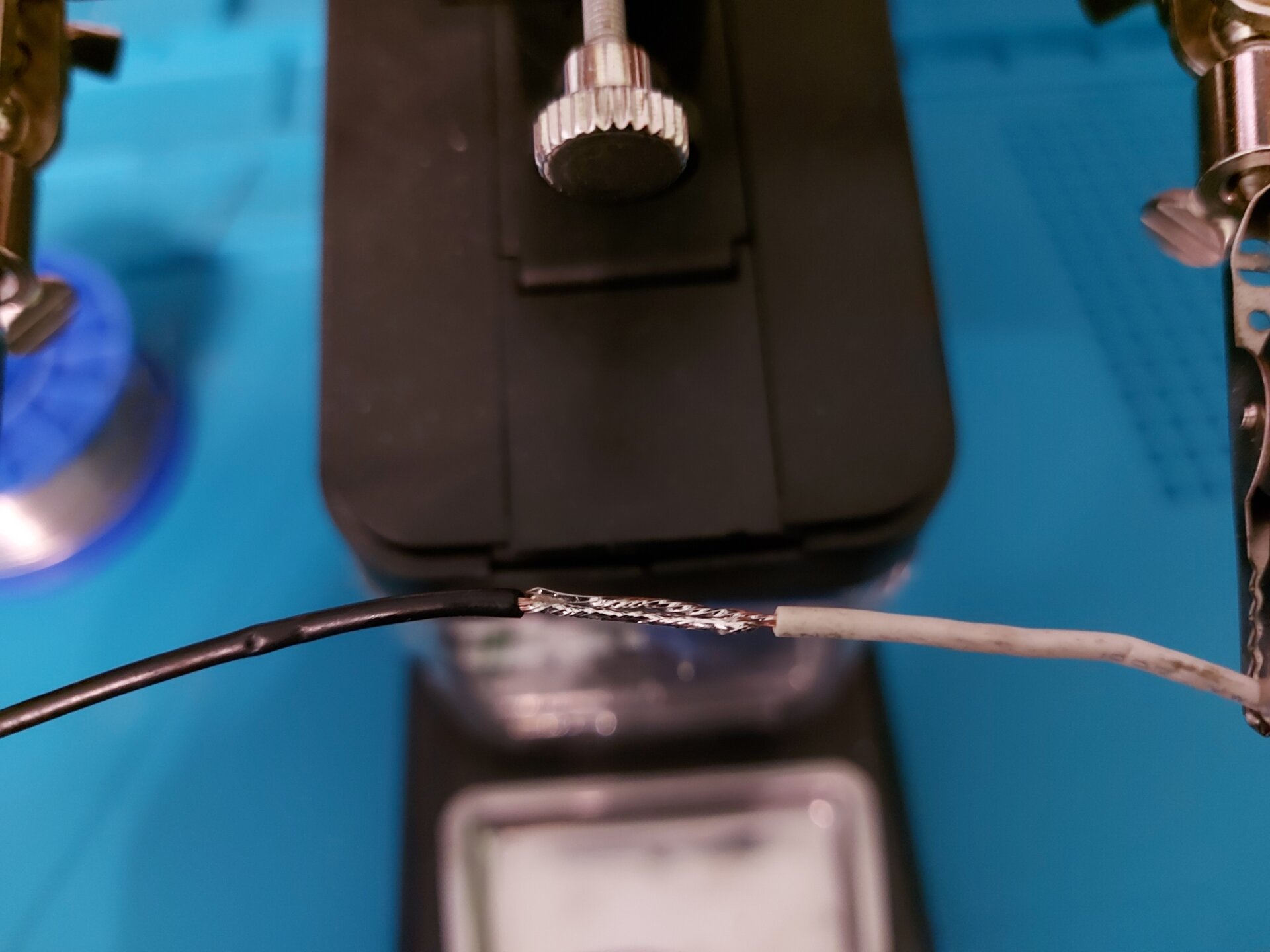 Zdjęcie przedstawia 2 przewody z usuniętą izolacją tym samym odsłaniając miedziane wnętrze, które zlutowano ze sobą nakładając oba kable na siebie.