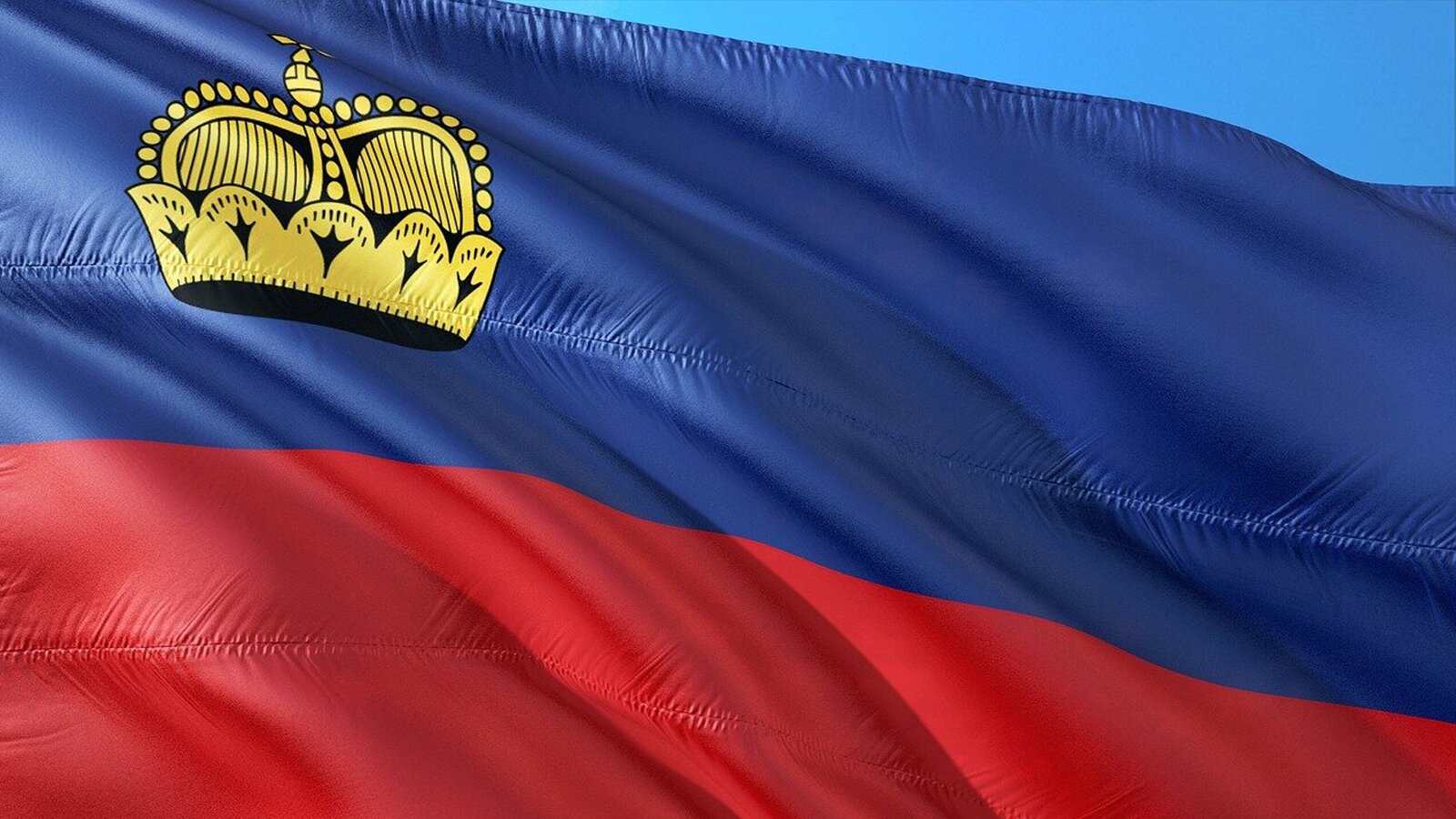 Ilustracja przedstawia niebiesko czerwoną flagę Lichtensteinu  