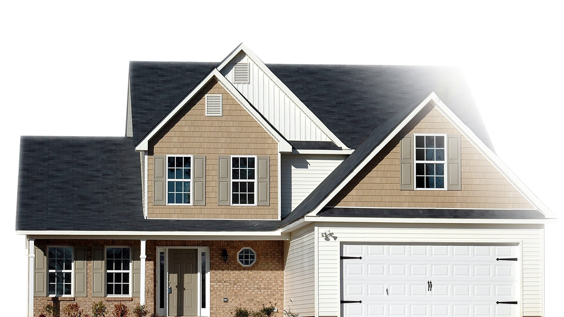 Na zdjęciu znajduje się domek jednorodzinny ze spiczastym dachem i garażem.