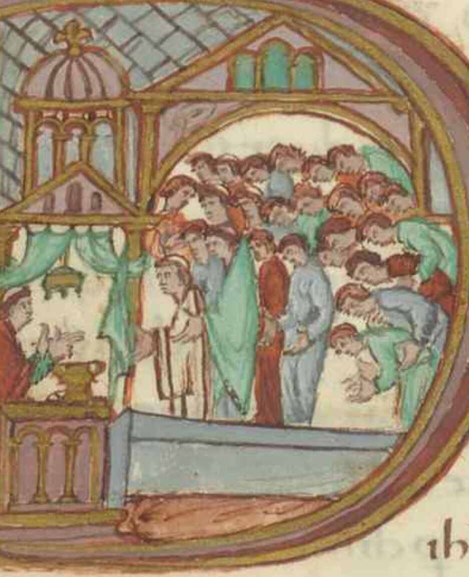 Na ilustracji strona z księgi liturgicznej. W budynku siedzi mnich nad naczyniami. Na przeciwko niego inny duchowny, a zanim kłaniają się ludzie.