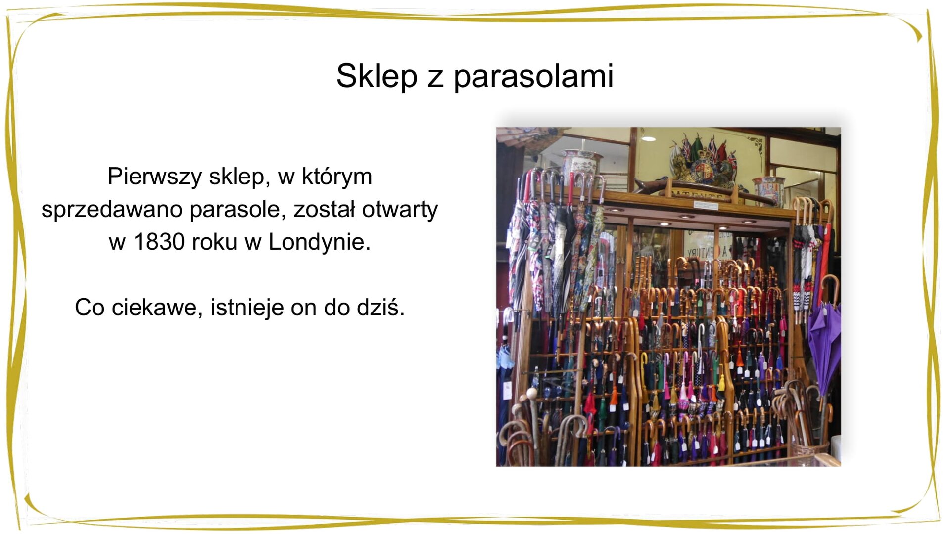 Kliknij, aby powiekszyć. W nagłówku widnieje napis: Sklep z parasolami. Poniżej po lewej stronie widać tekst: Pierwszy sklep, w którym sprzedawano parasole, został otwarty w 1830 roku w Londynie. Co ciekawe, istnieje on od dziś. Po prawej stronie znajduje się zdjęcie wnętrza sklepu z parasolami – widać regał, na którym ustawiono wiele, różnokolorowych parasoli.