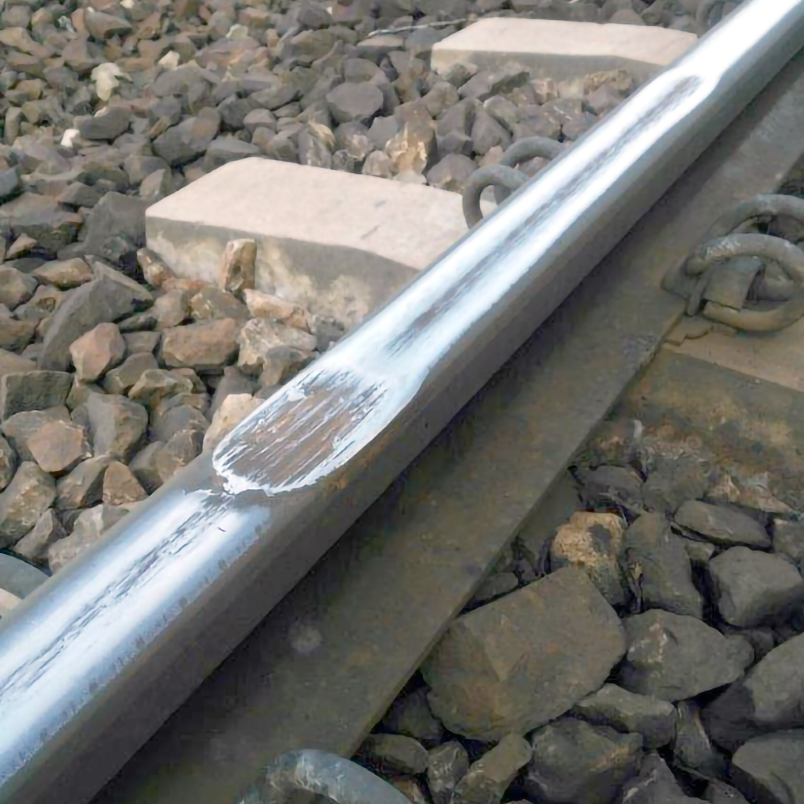 Ilustracja przedstawia tor kolejowym na którym widoczne jest wybuksowanie powierzchni tocznej szyny, wybuksowanie przedstawione jest jako zdarcie powierzchni tocznej szyny. Zdarcie nie występuje na całej powierrzchni tocznej szyny, tylko w pewnym miejscu.