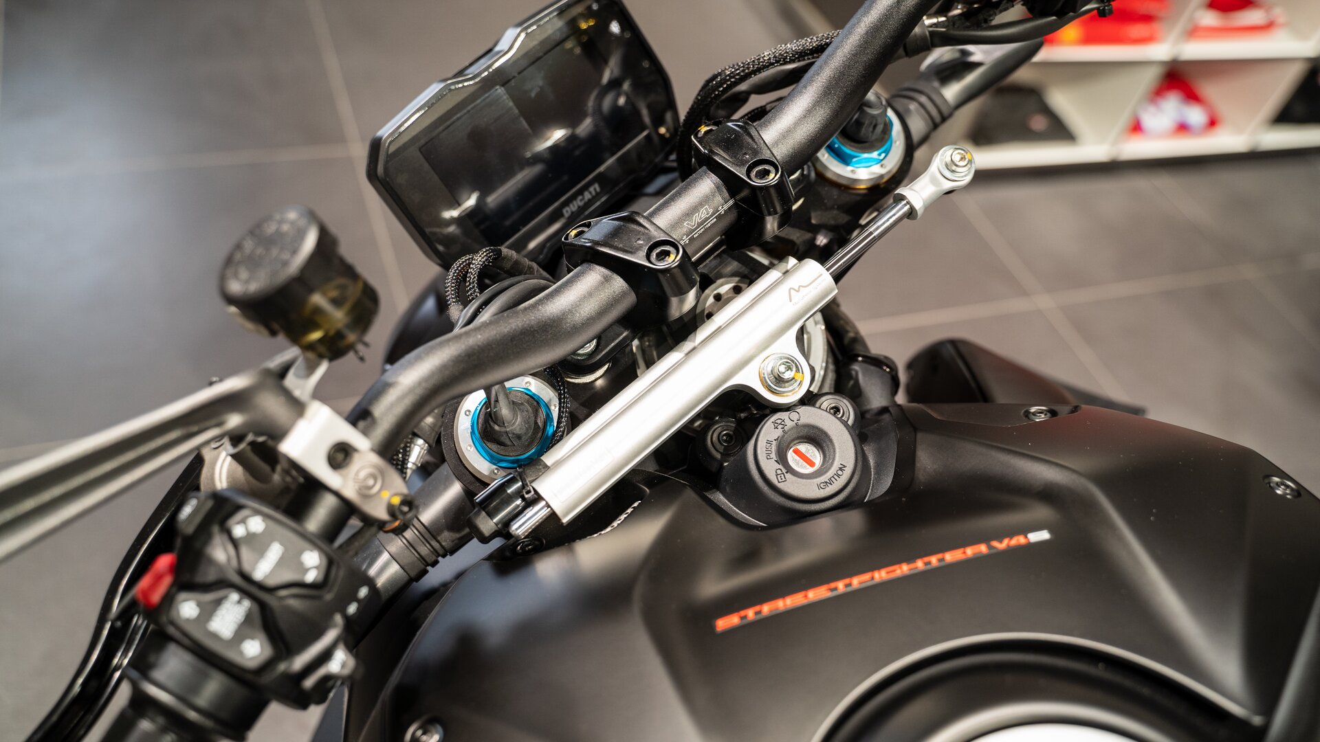 Zdjęcie przedstawia zbliżenie na kierownicę motocykla. Tam przyciski.  