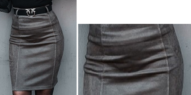 Zdjęcie przedstawia szarą, wąską i sięgającą przed kolano spódnicę, która marszczy się z przodu.