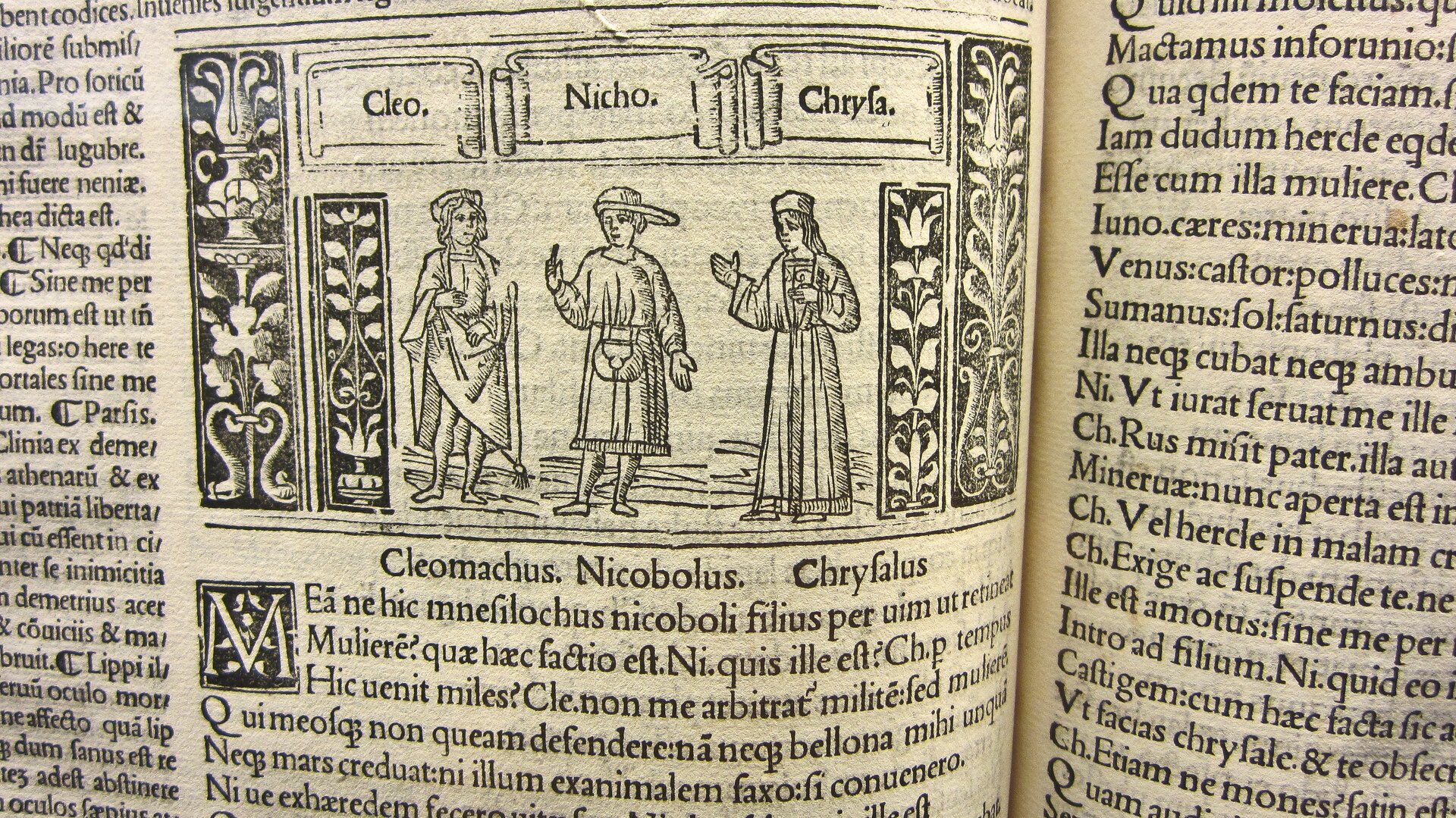 Fotografia przedstawiająca ilustrację z książki Plauta pod tytułem „Bacchides”. W centrum ukazane są trzy postacie podpisane jako: Cleomachus, Nicobolus, Chryfalus. Wokół nich znajduje się tekst w języku łacińskim.