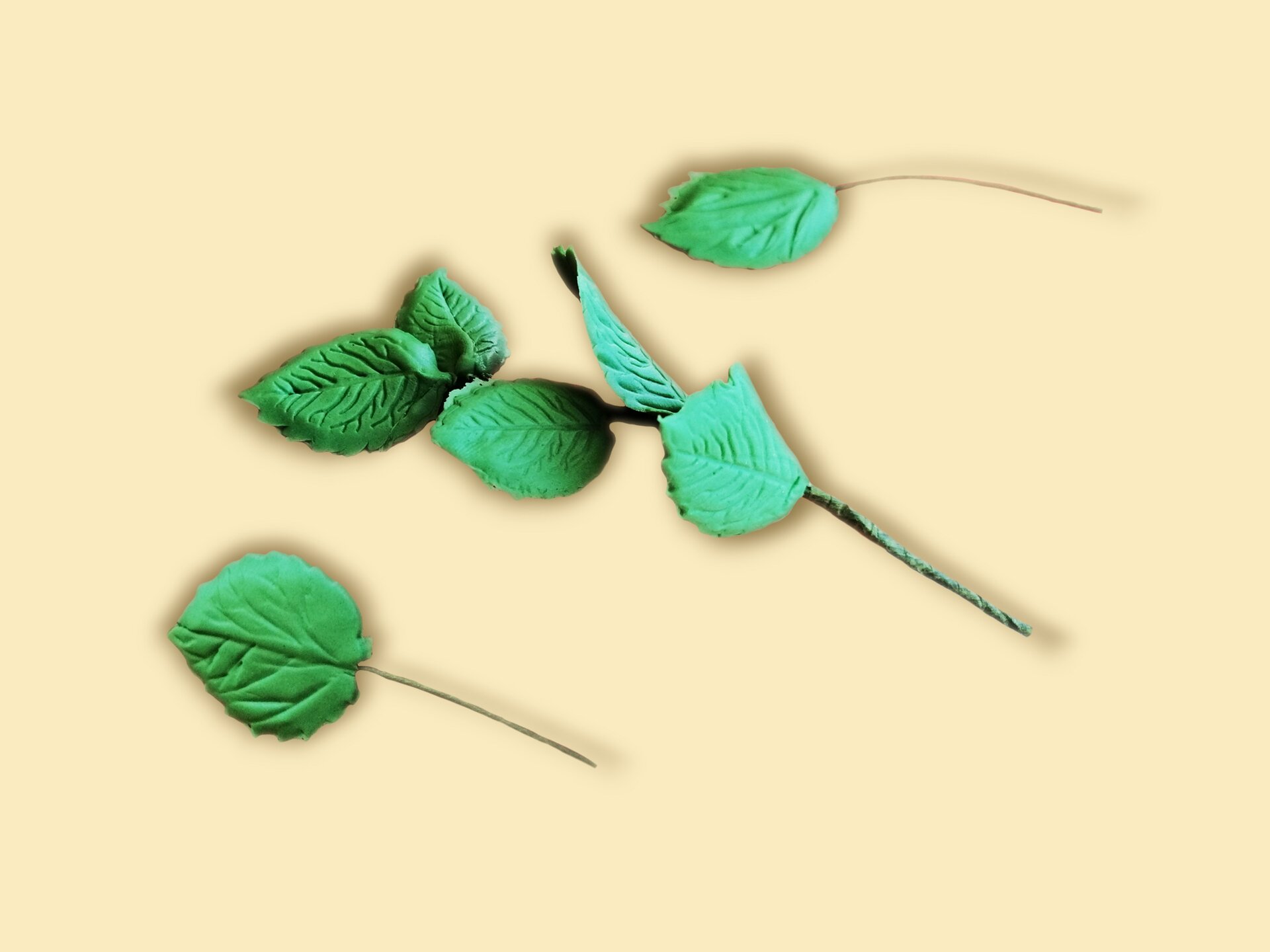 Pojedyncze liście z masy cukrowej, mocowane na drucikach florystycznych.
