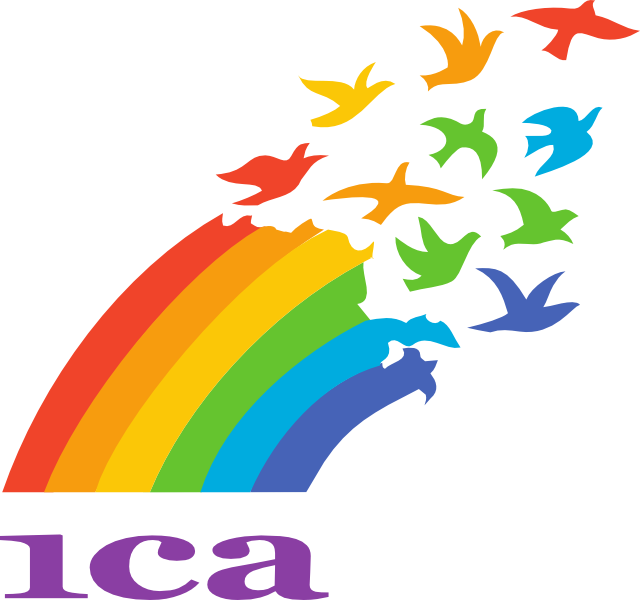 Zdjęcie przedstawia flagę opatrzone napisem "A C I " oraz fragment tęczy. Na końcu tęczy widoczne są odfruwające ptaki, które są ubarwione zgodnie z poszczególnymi kolorami tęczy.