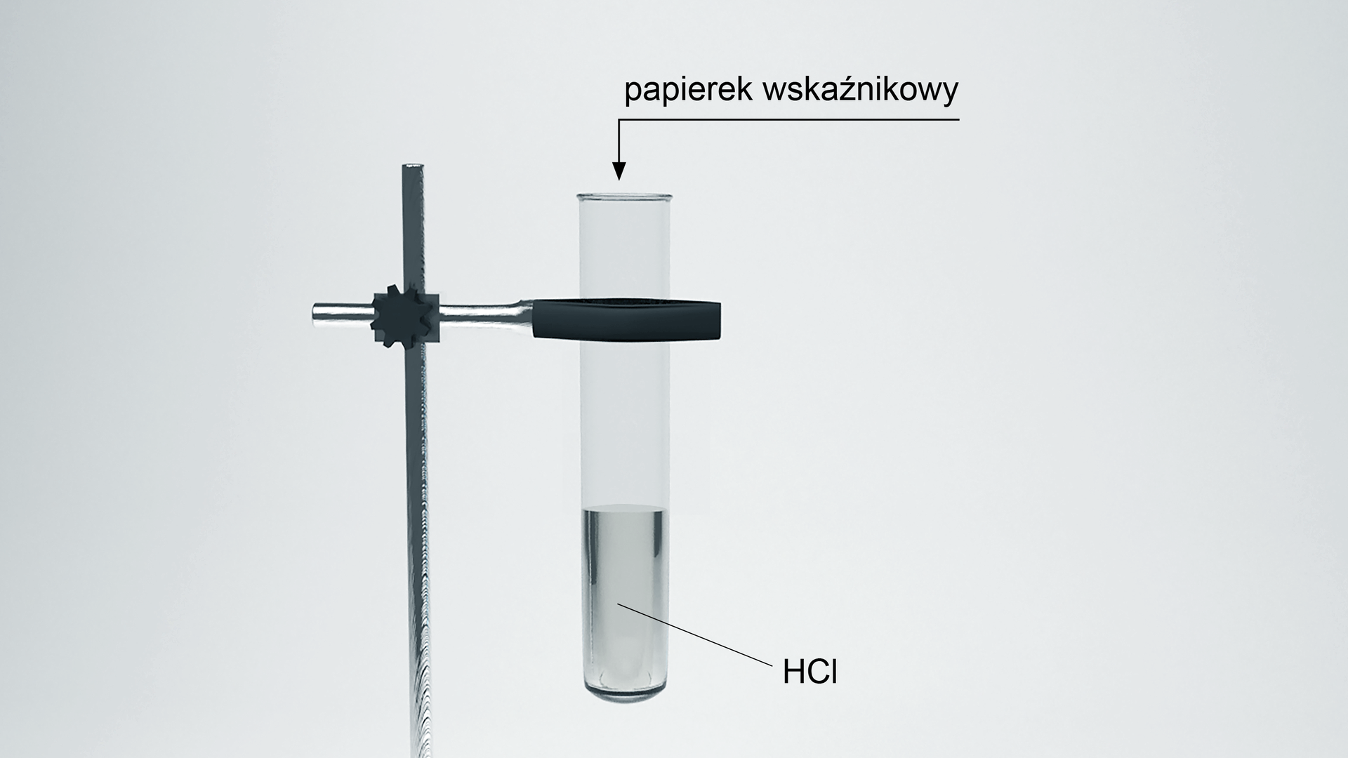 Na zdjęciu jest probówka umocowana do chwytnika stojaka. W probówce znajduje się roztwór HCl. Nad probówką zamieszczono strzałkę z podpisem: papierek wskaźnikowy.