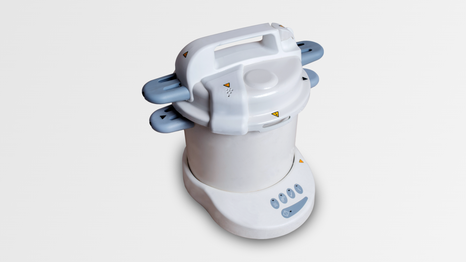 Na zdjęciu przedstawiony jest autoklaw. Hermetycznie zamykany pojemnik w kształcie walca umieszczony jest w podstawce, na której znajdują się przyciski sterujące.