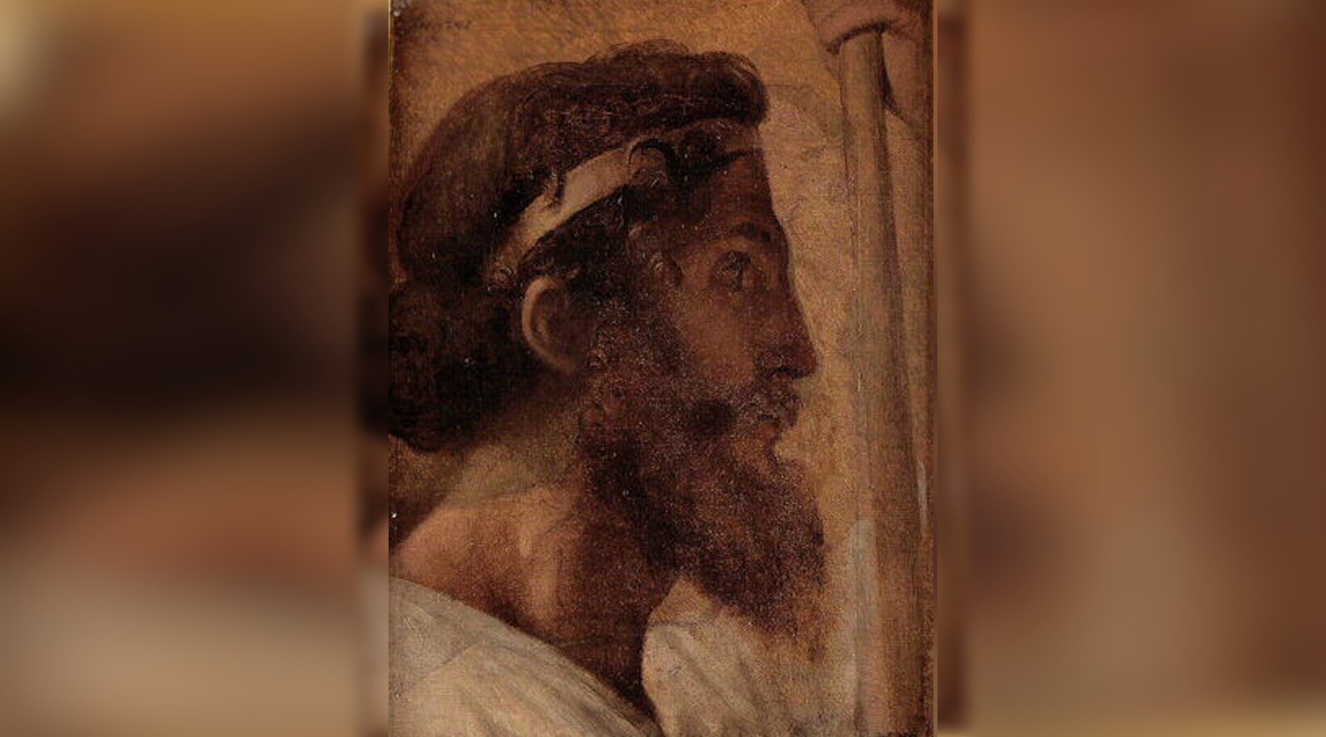 Obraz przedstawia prawy profil dojrzałego mężczyzny. Mężczyzna ma bujne włosy przewiązane przepaską na głowie. Ma bujną, długą, kręconą brodę.