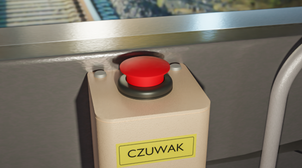 Zdjęcie przedstawia czuwak aktywny. Ma on postać skrzynki przymocowanej do ścian. Na przedniej jego ścianie znajduje się żółta naklejka z czarnym napisem czuwak. Na górze skrzynki znajduje się duży czerwony przycisk. 