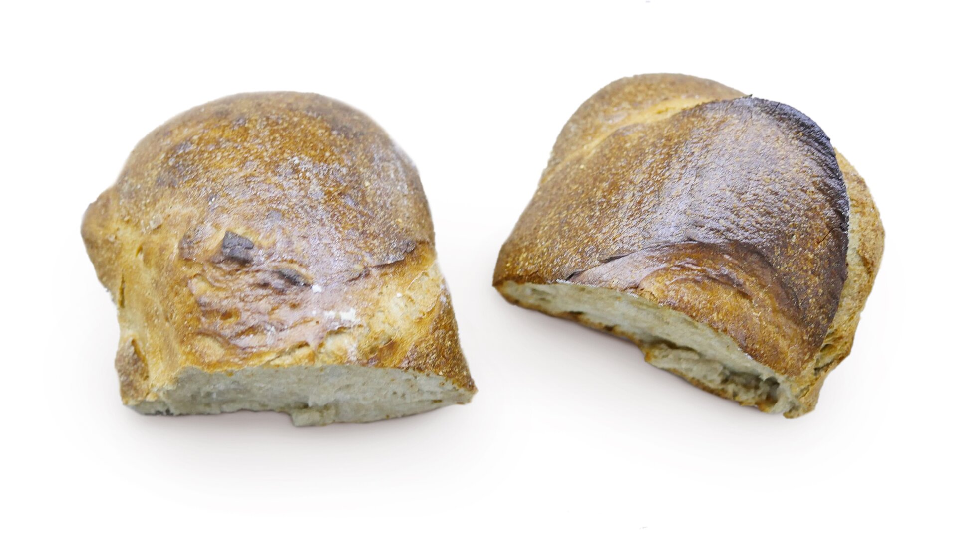 Zbliżenie przekroju kęsa ciasta pszennego pokazujące strukturę w fazie wypieku z wadą przepieczenia