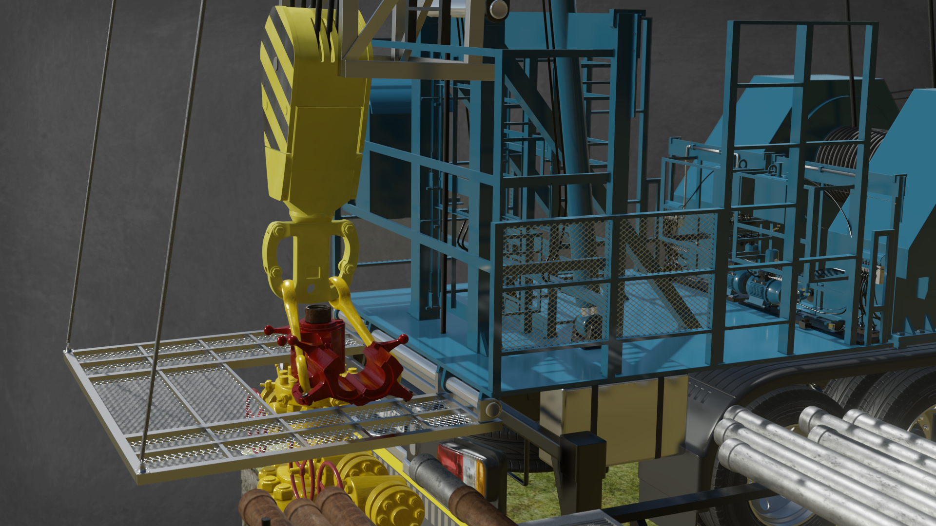 Na zdjęciu widoczny jest podest roboczy widziany pod katem. Podest wraz z barierkami zabezpieczającymi jest w kolorze niebieskim. Podest znajduje się na podwoziu ciężarówki. Z przodu podestu wychodzi stalowa konstrukcja przypominająca drabinę. Poniżej podestu znajduje się żółta głowica zamykająca otwór wiertniczy. Głowica jest w kształcie dużego znaku plus. Głowica  przechodzi przez otwór w  stalowym opuszczanym elemencie stanowiącym przedłużenie podestu. Po prawej stronie widać stelaż ze znajdującymi się na nim rurami.Z lewej strony samochodu znajduje się drabina po której można dostać się na podest.